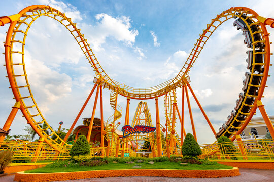 Roller coaster at Suan Siam Amazing Amusement park on sunny day, selective focus. Colorful children's playground  in a bright beautiful day. Family, holidays, vacation concept.