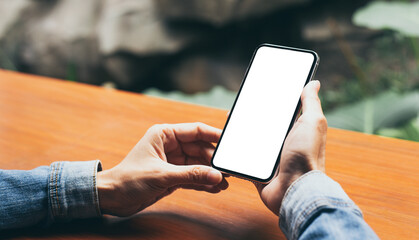 cell phone mockup image blank white screen.woman hand holding texting using mobile on desk at coffee shop.background empty space for advertise.work people contact marketing business,technology