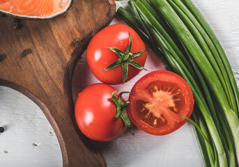 Fresh whole and half cut tomatoes with green herbs