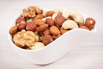 Various nuts and almonds as source healthy natural vitamins, nutritious eating concept