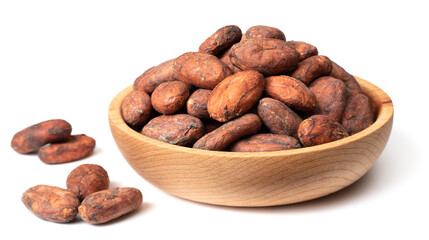 unpeeled cocoa beans in the wooden bowl, isolated on white background