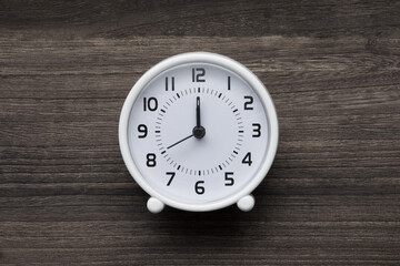White clock on a wooden background