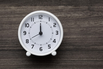 White clock on a wooden background