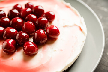 Fresh cheesecake with cherries on the rustic background. Selective focus. Shallow depth of field.
