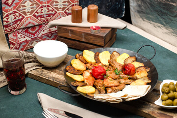 Caucasian sac ichi with meat and potatoes served with yogurt and composto