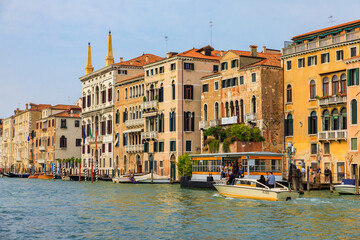 Gondolas along buildings on Grand Canal of Venice Italy