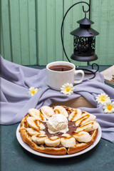Waffles served with banana and caramel sauce