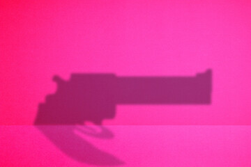 the shadow of a gun in the red background.