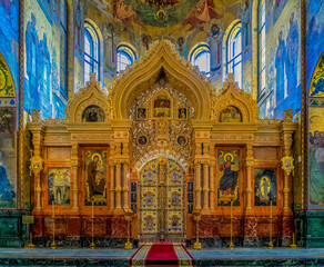 Fototapeta na wymiar Ornate golden altar and icons of the Savior on Spilled Blood or Cathedral of Resurrection of Christ in Saint Petersburg, Russia
