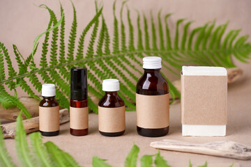 Herbal natural facial cosmetic products set with herbs on paper craft background, top view. Branding mock up, sustainable packaging, amber glass, eco-friendly wellness products, self-care focus - 359829315