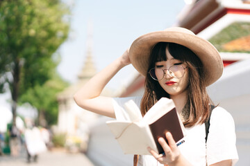 Young asian cute glasses teenager girl traveller backpack solo local travel with memo written daily.