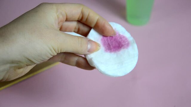 Close up image of woman using nail buffer when doing manicure, polishing nails at home. Smiling lady testing new beauty products and modern cosmetics, doing morning makeup or daily nail care routine