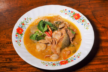 Red curry on wood background