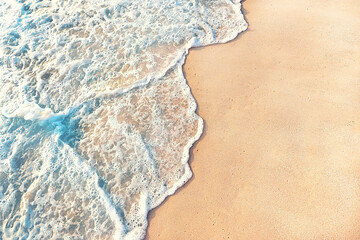 Fototapeta na wymiar clear water wave coming to the clean beach sand
