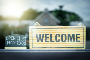 closeup welcome sign and opening time