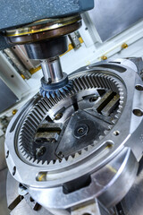 A modern CNC milling machine makes a large gear wheel.