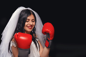 attractive brunette with red lipstick, in wedding dress, veil and Boxing gloves.