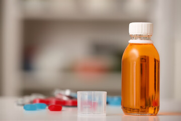 Bottle of cough syrup on table