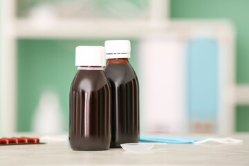 Bottles of cough syrup on table