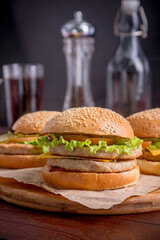 Three burgers on a blurry background