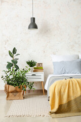 Stylish interior of bedroom with houseplants