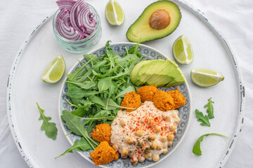 healthy superbowl or Buddha bowl with salad, baked sweet potatoes, chickpeas