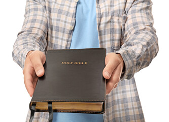 Young man with Bible on white background, closeup