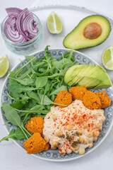 healthy superbowl or Buddha bowl with salad, baked sweet potatoes, chickpeas