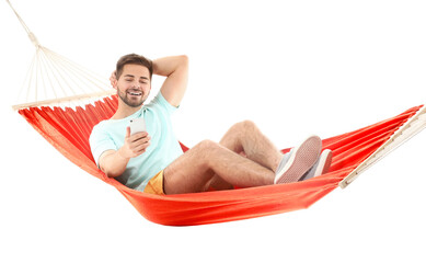 Young man with mobile phone relaxing in hammock against white background