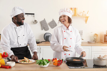 African-American chefs cooking in kitchen