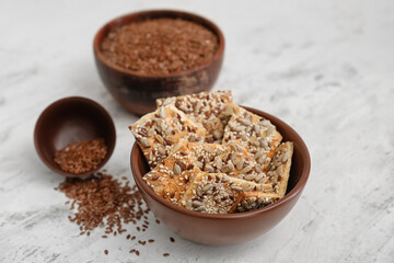 Bowls with cereal cookies and flax seeds on white background