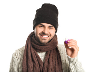 Handsome young man with lip balm on white background