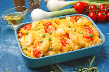 Tasty baked pasta in dish on color background