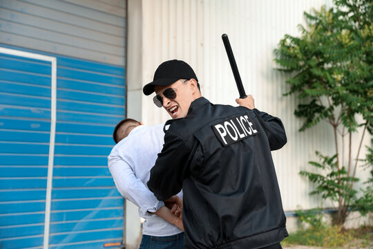 Aggressive Police Officer Mistreating Man Outdoors