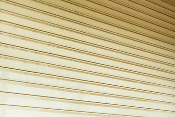 Cleaning the vinyl siding wall with a high-pressure washer.