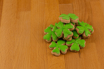holiday background St. Patrick's Day clover gingerbread pile on wooden background