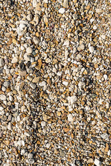 embankment of stone many mini pebbles gray and brown vertical pattern