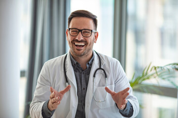 Cheerful male doctor shares advice during web conference. Doctor Having Video Conference On Laptop. Male doctor enjoys web conference. Video Chat with Patient by Doctor