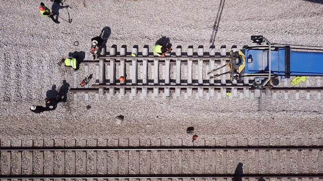 Railroad workers repairing a broken track. Repairing railway. Rail tracks maintenance process.