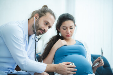 Fototapeta premium The beautiful pregnant women with the doctor at hospital for ultrasound checking to the baby.