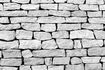gray cobblestone pattern from old and weathered stone background