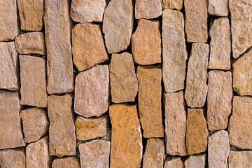old beige and brown stone vertical pattern uneven cobblestone background