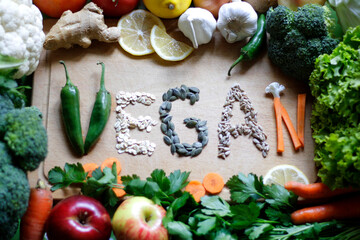 The word "VEGAN" written from vegetables and seeds