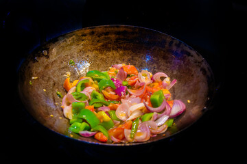 Stir fried colorful vegetables in a wok, Healthy food. Concept for a tasty and healthy vegetarian meal. Close up
