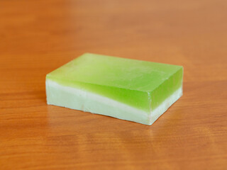Green handmade soap on a wooden background. Soap for spa close up