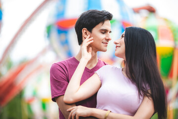 young couple having fun at an amusement theme park. Couple Dating Relaxation Love