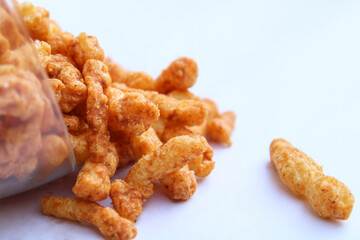 yummy tasty crunchy snacks drop from a transparent bowl