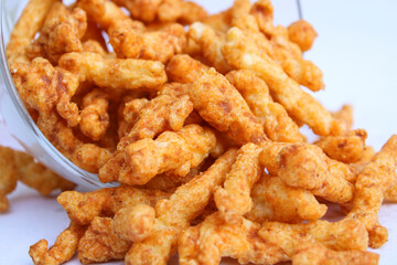 yummy tasty crunchy snacks drop from a transparent bowl