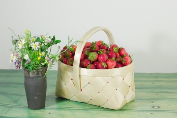 Summer still life with flowers and fresh strawberries 