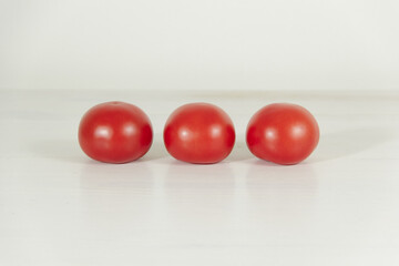 Three red tomatoes on a white background. Tomatoes for pizza. 